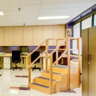 A rehabilitation room equipped with therapy stairs and exercise areas.