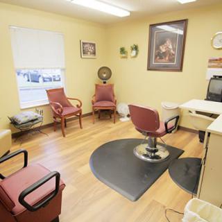 A cozy hair salon interior with a barber chair and waiting area.