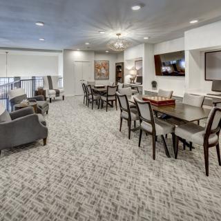 A modern and spacious lounge area with ample seating and elegant furnishings.