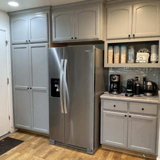 A well-organized kitchen with gray cabinets and stainless steel appliances.