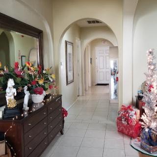 A beautifully decorated hallway for the Christmas season, showcasing festive decor and greenery.