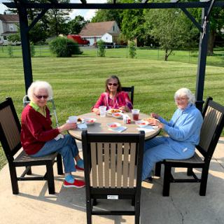Three friends enjoying a sunny afternoon together outdoors.