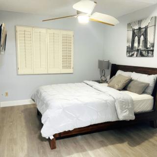 A modern, minimalist bedroom with a cozy bed and stylish decor.