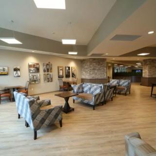 A modern lobby area with comfortable seating and artwork on the walls.