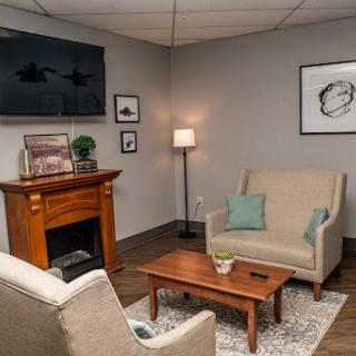 A cozy living room setup featuring comfortable seating, a wooden coffee table, and a stylish fireplace.