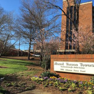 The Edward Vernon Torrence building surrounded by greenery and clear blue skies.