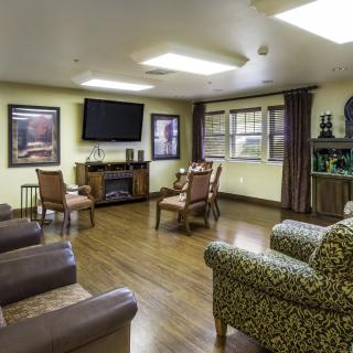 A cozy living room with comfortable seating, a television, and decorative elements.