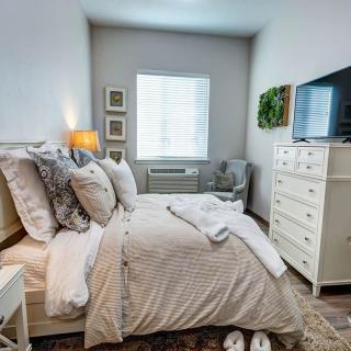 A cozy bedroom with elegant decor and a comfortable bed.