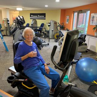 An elderly individual engaging in a workout session at the gym, showcasing dedication to fitness and health.