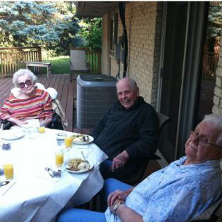 A group of seniors enjoying an outdoor meal together.
