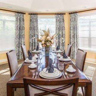 Elegant dining room with a beautifully set table and decorative centerpiece.
