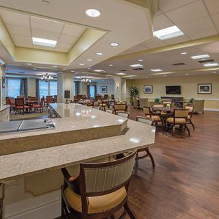 A modern dining area featuring tables, chairs, and ample lighting.