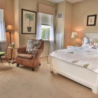A cozy bedroom with elegant furnishings and warm lighting.