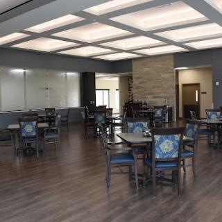 A spacious and modern dining area with wooden floors and stylish furniture.