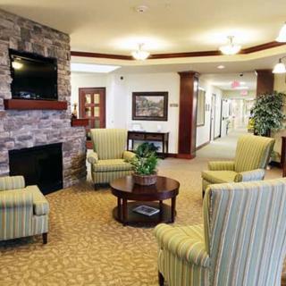 A cozy living room with armchairs, a fireplace, and modern decor.