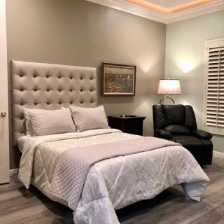 A cozy and stylish bedroom featuring a comfortable bed and a relaxing seating area.