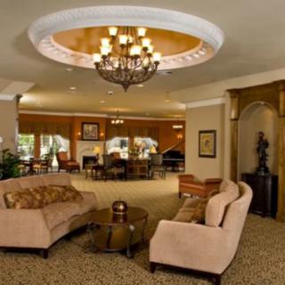 A luxurious living room with elegant furniture and a striking chandelier.