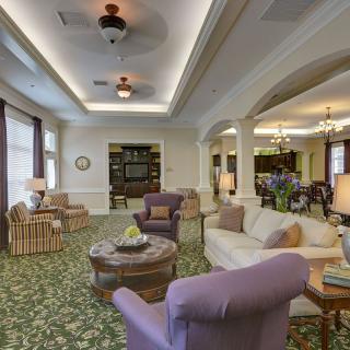 Spacious and elegantly decorated living room with comfortable seating and soft lighting.