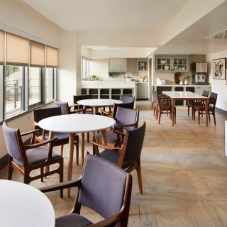 A modern kitchen and dining area with wooden floors and contemporary furnishings.
