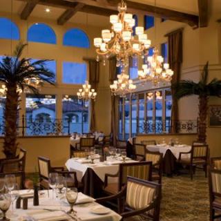 A beautifully decorated restaurant with elegant chandeliers and well-arranged dining tables.
