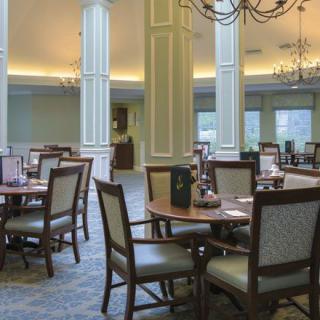 An elegant dining room with neatly arranged tables and chairs.