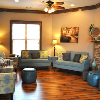 A cozy living room with modern furnishings and warm lighting.