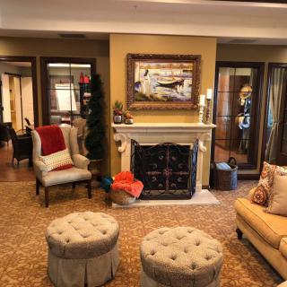 A cozy living room with elegant furniture, a fireplace, and warm decor.