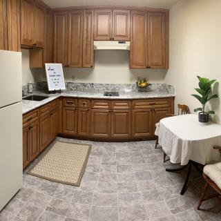Cozy kitchen with wooden cabinets and a small dining area.