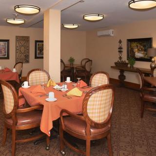 A cozy dining room with neatly arranged tables and elegant decor.