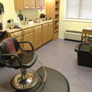 A well-organized hair salon with chairs and styling equipment.