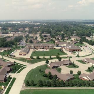An aerial perspective of a well-planned suburban neighborhood, showcasing the greenery and layout of residential streets.