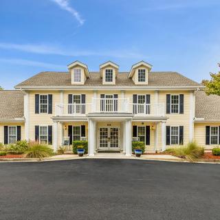 A large colonial-style house with a symmetrical facade and prominent entrance.