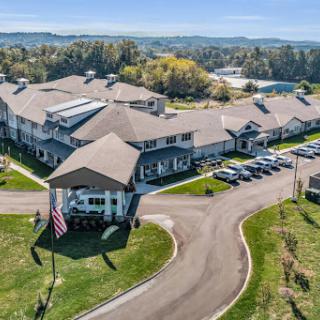 Aerial view of a resort with well-maintained grounds and a parking area.