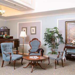 A cozy sitting area with antique furniture and tasteful decor.