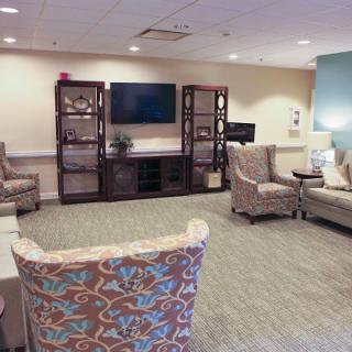 A cozy living room with comfortable seating and a large television.