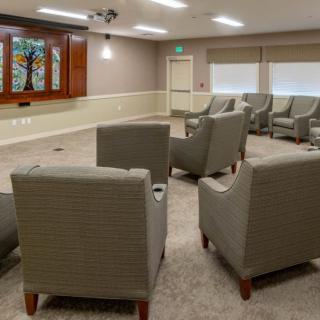 A cozy meeting room with arranged seating and a television.