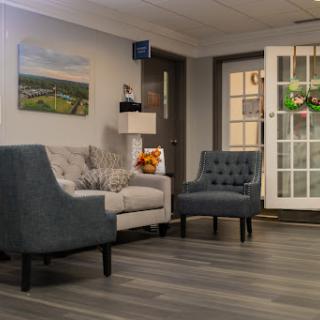 A cozy living room featuring a gray sofa, armchair, and a welcoming atmosphere.