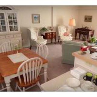 A cozy living room with a traditional dining area and comfortable seating.