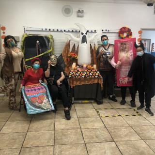 A lively group dressed in various costumes for a Halloween-themed celebration.