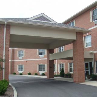 A brick building with a covered entrance.