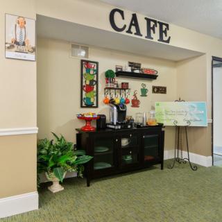 A cozy cafe setup with a coffee station, decorative elements, and a welcoming atmosphere.