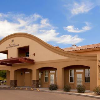 A beautiful exterior view of a hospitality building under a bright blue sky.