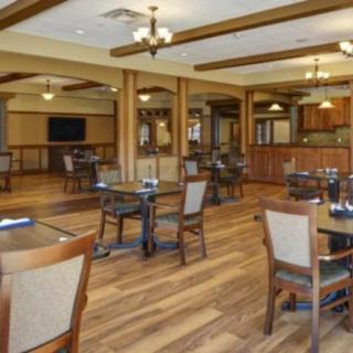 An elegant dining area with wooden flooring and modern furniture.