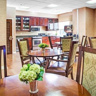 A modern kitchen and dining area with wooden furniture and elegant decor.