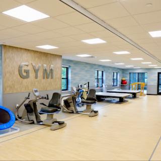 A modern gym featuring workout equipment and a spacious design.