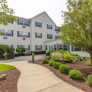 A residential building with a landscaped garden and pathway.