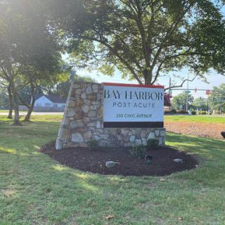 Welcome sign at a local park, surrounded by well-maintained landscaping.