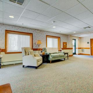 A spacious lounge area with comfortable seating and ample natural light.