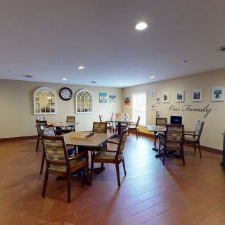 A cozy community room featuring tables and chairs for gatherings.