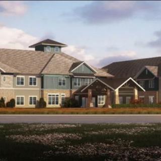 A modern residential building with a landscaped lawn in a suburban setting.